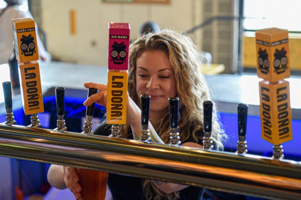 woman pouring beer in taproom x